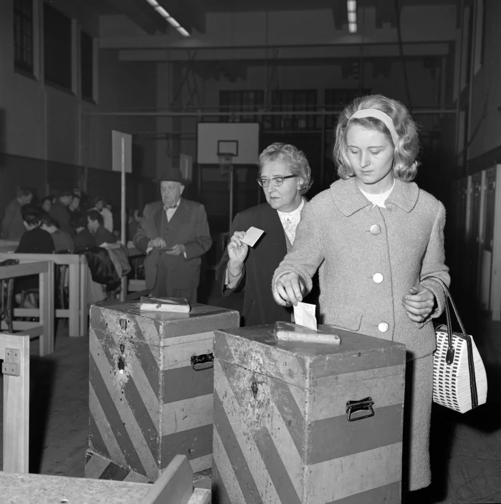 26. Oktober 1963: Frauen dürfen in Genf an die Urnen, um über kantonale Anliegen zu befinden – an den am gleichen Tag stattfindenen National- und Ständeratswahlen dürfen sie nichtteilnehmen. Als erster Kanton hatte die Waadt 1959 das Frauenstimmenrecht für kantonale Angelegenheiten eingeführt, Genf und Neuenberug folgten 1960. (Foto: Keystone/Photopress-Archiv/Str)