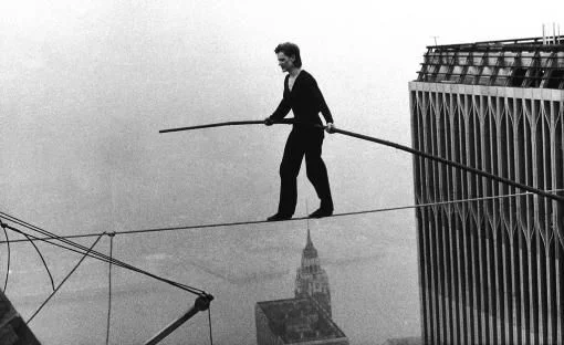 Der Franzose Philippe Petit „marschiert“ in einer Höhe von 417 Metern auf einem Drahtseil von einem Turm des New Yorker World Trade Centers zum anderen. Der damals fast 25-jährige Hochseilartist geht auf dem 2,5 Zentimeter dicken Seil acht Mal zwischen den Zwillingstürmen hin und her. Nach der illegalen Aktion wird er festgenommen und erscheint vor Gericht. Die Sicherheitsdienste sind perplex, weil es ihm gelungen war, das Seil zu spannen und auf den Turm zu gelangen. Nach dem riesigen positiven Medienecho…